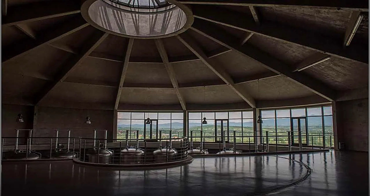 The round fermentation hall, ringed with glass and lit from a central oculus in the concrete roof.